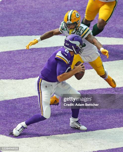 Kirk Cousins of the Minnesota Vikings gets sacked by Jaire Alexander of the Green Bay Packers in the second quarter at U.S. Bank Stadium on September...