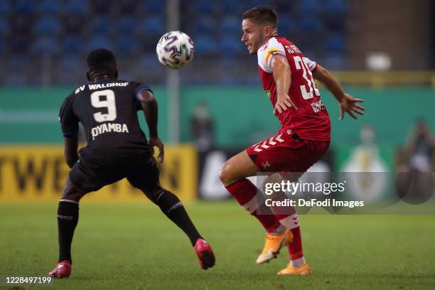 Joseph Boyamba of SV Waldhof Mannheimund Christian Guenter of SC Freiburg battle for the ball during the DFB Cup first round match between SV Waldhof...