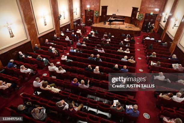 Members of the audience arrive to take their socially distanced seats in the auditorium for a performance by German baritone Christian Gerhaher and...