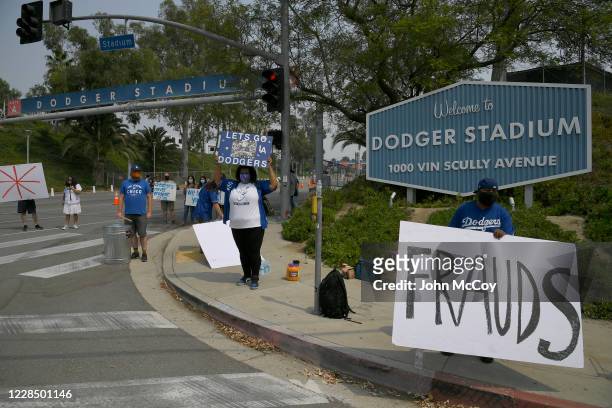 Los Angeles Dodgers fans stand at the front gate to confront the Houston Astros as they arrive for a game at Dodger Stadium on September 13, 2020 in...