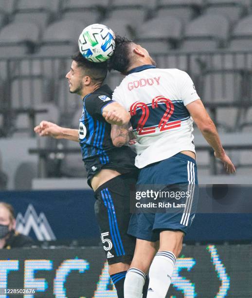 Erik Godoy of the Vancouver Whitecaps and Emanuel Maciel of the Montreal Impact battle for the ball during MLS soccer action at BC Place on September...