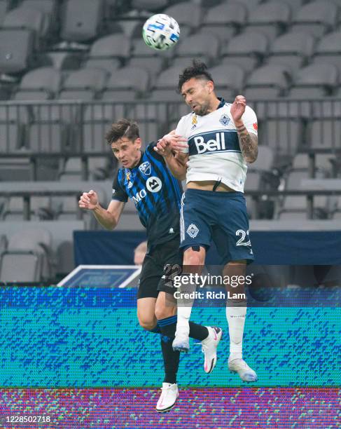 Erik Godoy of the Vancouver Whitecaps beats Jukka Raitala of the Montreal Impact for a header during MLS soccer action at BC Place on September 13,...