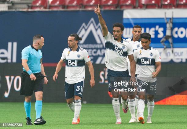 Thelonius Bair of the Vancouver Whitecaps celebrates with teammates Russell Teibert and Michael Baldisimo after scoring a goal against the Montreal...