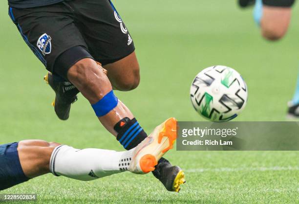 Michael Baldisimo of the Vancouver Whitecaps kicks the ball away from Saphir Taïder of the Montreal Impact during MLS soccer action at BC Place on...