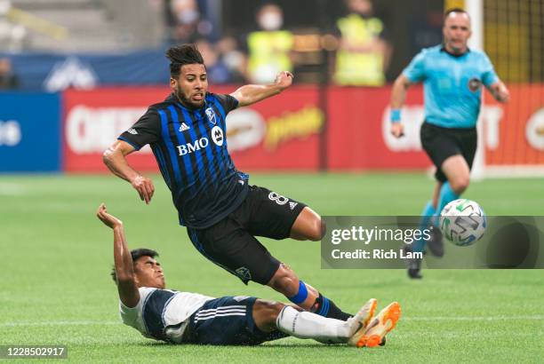 Michael Baldisimo of the Vancouver Whitecaps delivers a successful slide tackle to knock the ball away from Saphir Taïder of the Montreal Impact...