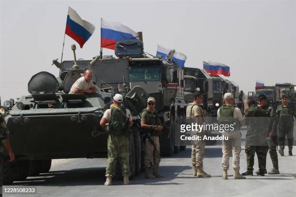 Russian military vehicles drive on the road as Russia makes a new military and logistic reinforcement of 30 vehicles to its military points in...