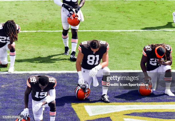 Cleveland Browns safety Sheldrick Redwine , wide receiver JoJo Natson , tight end Austin Hooper and running back Kareem Hunt kneel in end zone before...