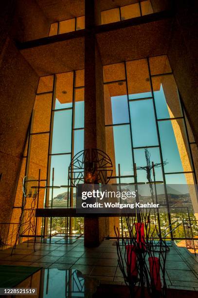 The interior of the Chapel of the Holy Cross with the altar and a view window in Sedona, Arizona, USA.