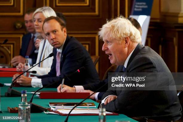 British Prime Minister Boris Johnson speaks as Secretary of State for Health and Social Care, Matt Hancock listens during a Cabinet Meeting at the...
