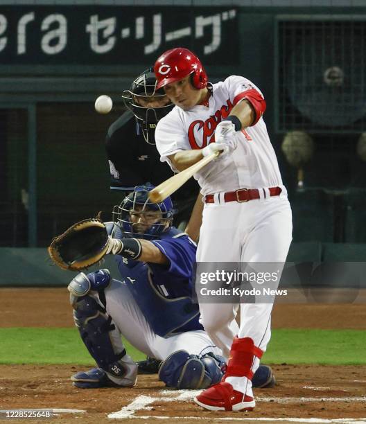 Seiya Suzuki of the Hiroshima Carp hits a three-run home run in the first inning of a game against the Chunichi Dragons at Mazda Stadium in Hiroshima...