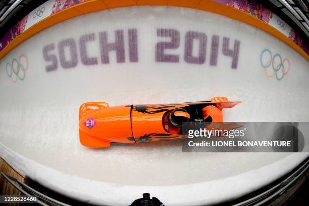 In this file photo taken on February 16, 2014 Netherlands-1 two-man bobsleigh steered by Edwin van Calker races in the Bobsleigh Two-man, Heat 2 at...