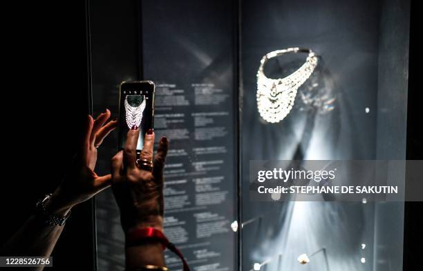 Visitor takes a picture of a necklace made of platinum and diamonds, which dates from 1939, and belonged to the Queen Nazli of Egypt, during the...