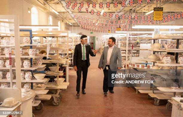 Britain's Chancellor of the Exchequer Rishi Sunak talks to operations director Graham Bolton during his visit to the Emma Bridgewater pottery in...