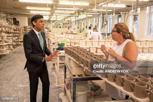 Britain's Chancellor of the Exchequer Rishi Sunak talks with Michelle Oakes during his visit to the Emma Bridgewater pottery in Stoke-upon-Trent,...