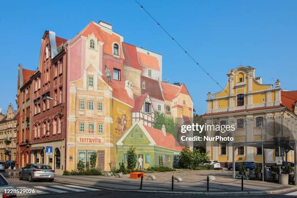 Giant mural named ' Srodka story with a bugler on the roof and a cat in the backgroundat ' at the Srodka street is seen in Poznan, Poland on '12...