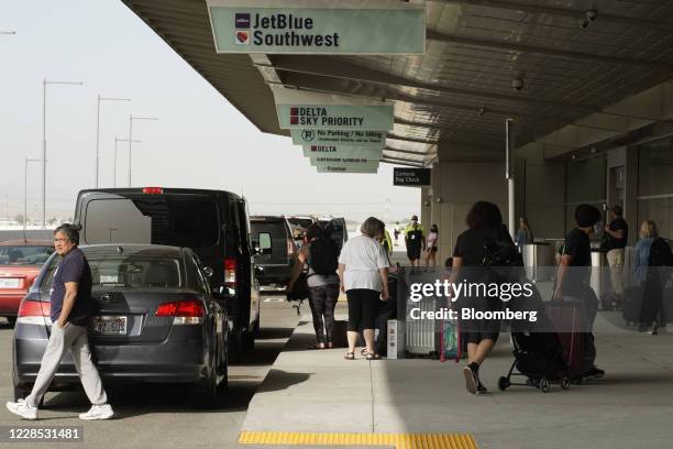 Travelers arrive for flights on opening day of the Salt Lake City International Airport in Salt Lake City, Utah, U.S., on Tuesday, Sept. 15, 2020....