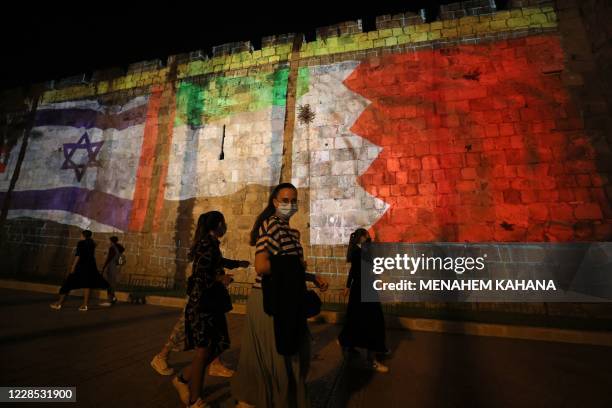 The flags of Israel, United Arab Emirates, and Bahrain are projected on the ramparts of Jerusalem's Old City on September 15, 2020 in a show of...