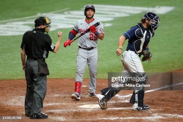 Umpire Dan Iassogna signals the strikeout of Yadiel Hernandez of the Washington Nationals as Kevan Smith of the Tampa Bay Rays reacts in the ninth...