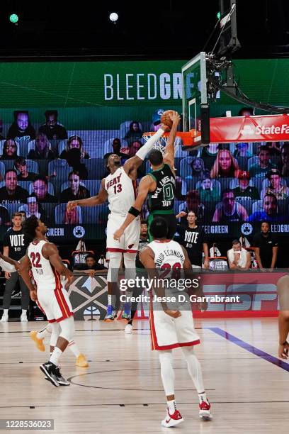 Bam Adebayo of the Miami Heat blocks a dunk attempt in the game against Jayson Tatum of the Boston Celtics during Game One of the Eastern Conference...