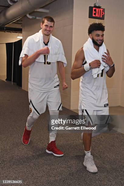 Nikola Jokic and Jamal Murray of the Denver Nuggets walk off the court to the locker room together after winning Game Seven of the Western Conference...