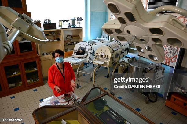 In this photograph taken on September 15 Annick Le Mescam, president of the Hospital heritage conservatory poses amongst items of equipment including...