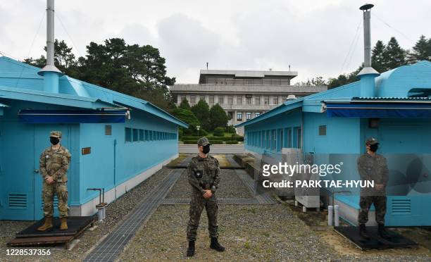South Korea and US soldiers stand guard outside the conference building of United Nations Command Military Armistice Commission during a visit of...
