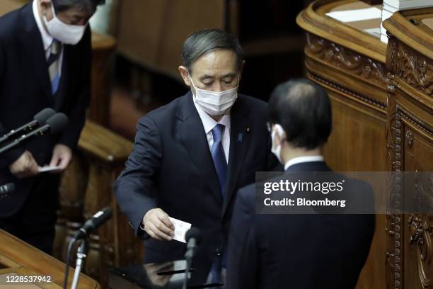 Yoshihide Suga, president of the Liberal Democratic Party , casts his ballot for the nomination of Japan's prime minister during an extraordinary...