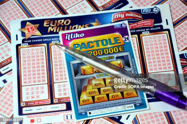 In this photo illustration a pen and a scratch card on Euromillions tickets. A couple from Alsace pocketed the 157 million euros of the Euromillions...