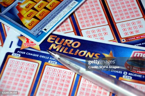 In this photo illustration a pen and a scratch card on Euromillions tickets. A couple from Alsace pocketed the 157 million euros of the Euromillions...