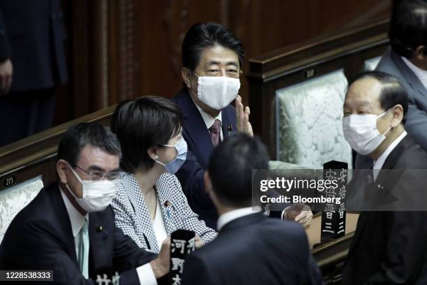 Shinzo Abe, Japan's former president of the Liberal Democratic Party , center, greets another lawmaker as he attends an extraordinary session at the...