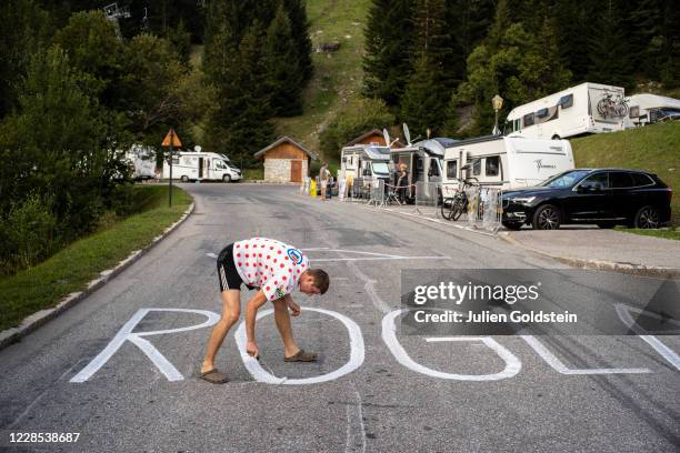 Two Slovenian fans are paint the road in honor of Primos Roglic ahead of the 17th stage of the Tour de France on September 15, 2020 in Meribel,...