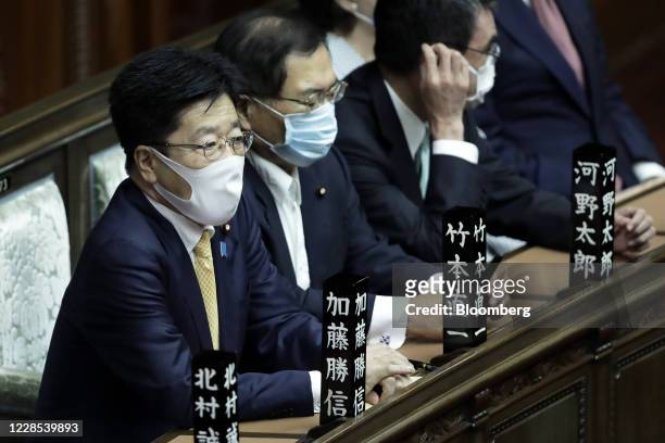Katsunobu Kato, Japan's health minister, left, attends an extraordinary session at the lower house of parliament in Tokyo, Japan, on Wednesday, Sept....