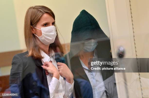 September 2020, Bavaria, Munich: A co-defendant is standing next to her lawyer Eva Krötz at the start of the trial against her on suspicion of a...