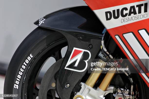 Bridgestone tyre is seen installed on board Australian Casey Stoner's Ducati before the first free practice session at the Sepang International...