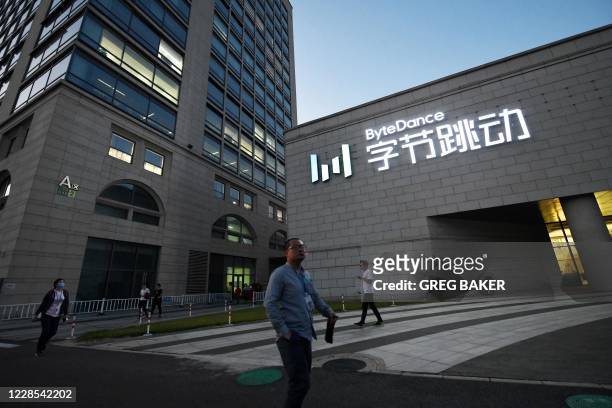 People walk past the headquarters of ByteDance, the parent company of video sharing app TikTok, in Beijing on September 16, 2020. - Silicon Valley...