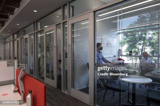 Employees wear protective masks at a JLL office in Menlo Park, California, U.S., on Tuesday, Sept. 15, 2020. Constraints such as social distancing...