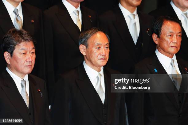 Yoshihide Suga, Japan's prime minister, front row center, poses for a group photograph with his new cabinet members at his official residence in...