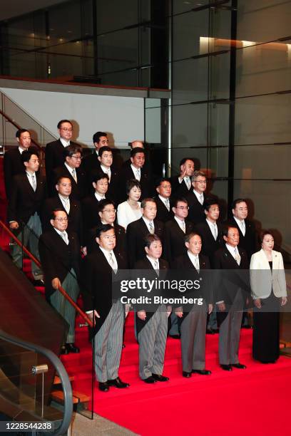 Yoshihide Suga, Japan's prime minister, front row center, poses for a group photograph with his new cabinet members at his official residence in...