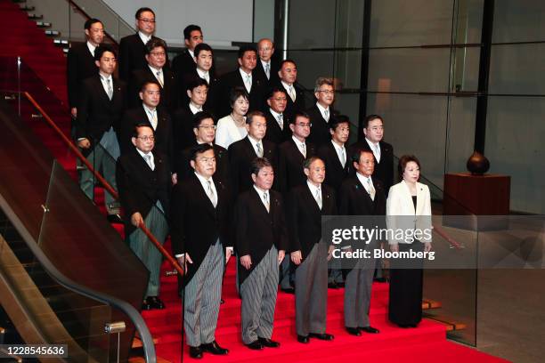 Yoshihide Suga, Japan's prime minister, front row center, poses for a group photograph with his new cabinet members at his official residence in...