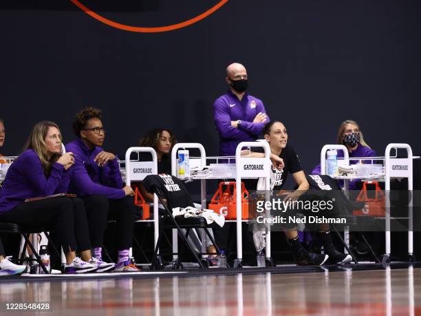 Assistant Coaches Julie Hairgrove, Chasity Melvin, and Diana Taurasi of the Phoenix Mercury look on during the game against the Minnesota Lynx on...