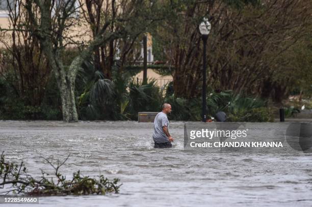 Man walks through a street by rains from Hurricane Sally in downtown Pensacola, Florida, on September 16, 2020. - Hurricane Sally barrelled into the...