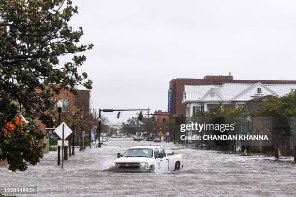 City worker drives through the flooded street during Hurricane Sally in downtown Pensacola, Florida on September 16, 2020. - Hurricane Sally...