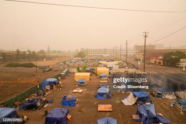 Camp for people experiencing homelessness near the east side of the Hawthorne Bridge as smoke from wildfires fills the air in Portland, Oregon, U.S.,...