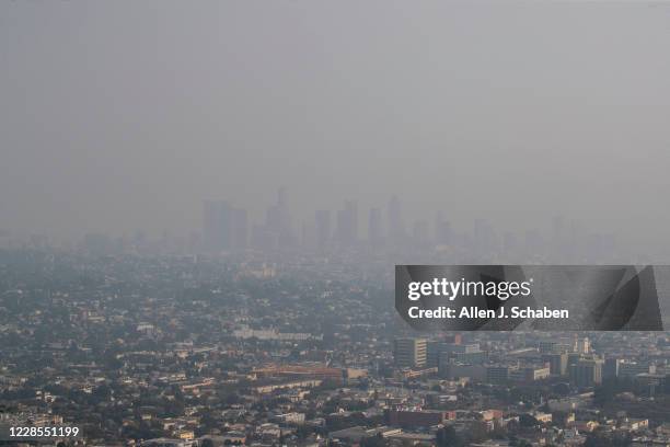 The view of downtown Los Angeles skyline is obscured by smoke, ash and smog as seen from the Griffith Observatory Monday, Sept. 14, 2020 in Los...