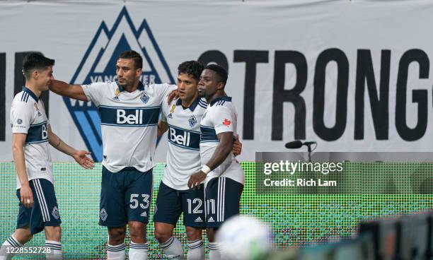 Fredy Montero of the Vancouver Whitecaps is congratulated by teammates Ali Adnan, Cristian Dajome and Cristian Gutierrez after scoring a goal against...