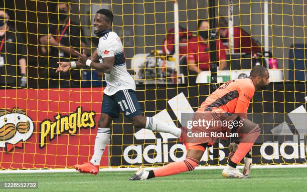 Cristian Dajome of the Vancouver Whitecaps runs past goalkeeper Clement Diop of the Montreal Impact after scoring a goal during MLS soccer action at...