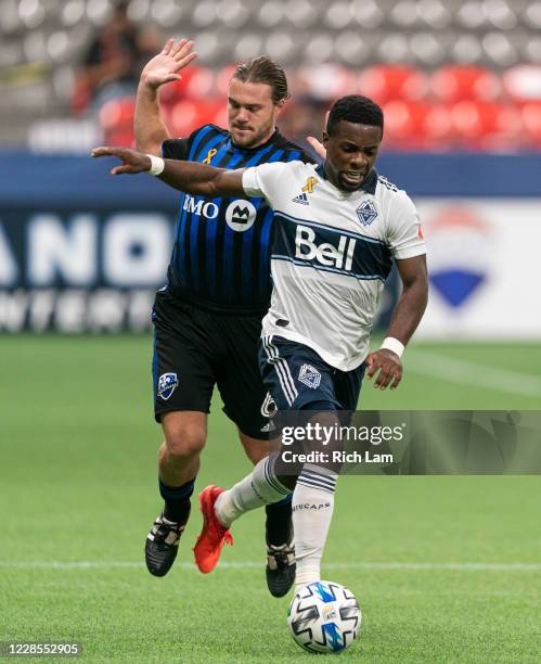 Cristian Dajome of the Vancouver Whitecaps gets past Saphir Taider of the Montreal Impact during MLS soccer action at BC Place on September 16, 2020...