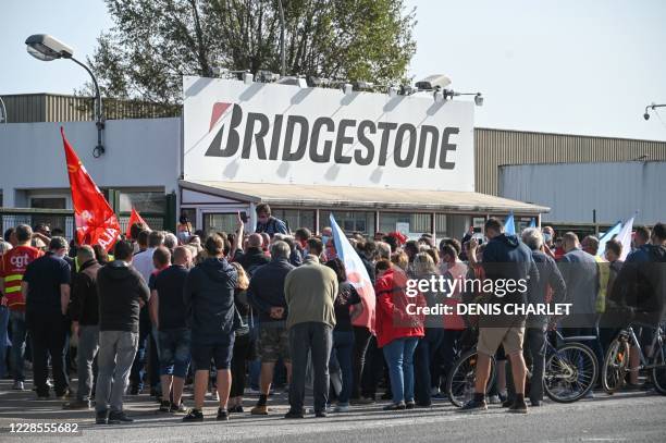 Trade unionists and employees gather during a demonstration in front of the Japanese tyre manufacturer Bridgestone plant in Bethune, northern France,...