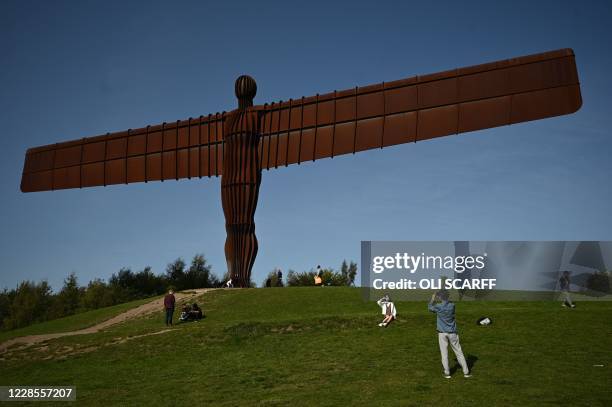 Visitors are seen at the iconic sculpture designed by Antony Gormley 'Angel of the North' in Gateshead, northeast England, on September 17, 2020. The...