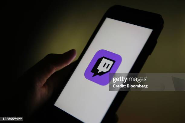 Smartphone displays a logo for the Twitch streaming app, operated by Amazon.com Inc., in this arranged photograph in London, U.K., on Thursday, Sept....